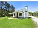 Charming home featuring a covered porch, well-maintained lawn, and gravel driveway at 3556 Finch Sw Rd, Powder Springs, GA 30127