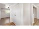 Hallway featuring tile floors, closet with gold knobs, and an entry to another room at 3556 Finch Sw Rd, Powder Springs, GA 30127