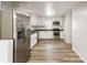 Bright kitchen featuring stainless steel appliances, stone countertops, and white cabinets at 3556 Finch Sw Rd, Powder Springs, GA 30127