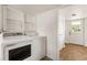 Laundry room with two windows and updated washer and dryer at 3556 Finch Sw Rd, Powder Springs, GA 30127