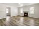 Cozy living room with a fireplace, wood-look floors, and lots of natural light at 3556 Finch Sw Rd, Powder Springs, GA 30127