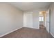 A bedroom featuring an open door, neutral walls, and carpeted floors at 3721 Longview Dr, Douglasville, GA 30135