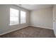 This bedroom has carpet, neutral colored walls, and two windows that bring in natural light at 3721 Longview Dr, Douglasville, GA 30135