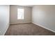 This bedroom has carpet, neutral colored walls, and a window that brings in natural light at 3721 Longview Dr, Douglasville, GA 30135