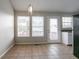 Bright dining room with tiled flooring and modern lighting fixture at 3721 Longview Dr, Douglasville, GA 30135