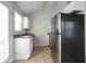 Galley kitchen with stainless steel refrigerator and range, plus tiled flooring at 3721 Longview Dr, Douglasville, GA 30135