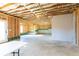 Unfinished basement with exposed wood framing, concrete floor, and some light fixtures at 417 Newland Way, Acworth, GA 30102