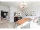 Bright bedroom featuring a decorative light fixture and dresser with a comfortable bed and view of the hallway at 417 Newland Way, Acworth, GA 30102
