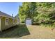 Spacious backyard featuring lush greenery and a detached garage at 6895 Brown S Dr, Fairburn, GA 30213