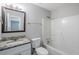 Bright bathroom featuring a granite-topped vanity and shower-tub combination at 6895 Brown S Dr, Fairburn, GA 30213