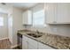Stylish kitchen with white cabinets, granite counters, stainless steel appliances, and hardwood flooring at 6895 Brown S Dr, Fairburn, GA 30213