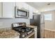 Modern kitchen showcasing stainless steel appliances, granite counters and white cabinets at 6895 Brown S Dr, Fairburn, GA 30213