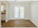 Open-concept living room with hardwood floors and plenty of natural light coming through the French doors at 6895 Brown S Dr, Fairburn, GA 30213