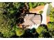 An aerial view shows a home with a pool, patio, and long driveway surrounded by mature trees at 7635 Blandford Pl, Atlanta, GA 30350
