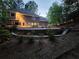 Scenic backyard featuring a custom pool, landscaping, and a multi-tiered deck and patio at 7635 Blandford Pl, Atlanta, GA 30350