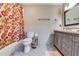 Cozy bathroom with a floral shower curtain, grey vanity, and tile flooring at 7635 Blandford Pl, Atlanta, GA 30350