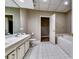 Bathroom features a double vanity sink, toilet, and shower with a bathtub at 7635 Blandford Pl, Atlanta, GA 30350
