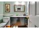 Stylish bathroom with a sleek vanity, decorative mirror, wainscoting, and modern fixtures at 7635 Blandford Pl, Atlanta, GA 30350