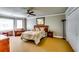 Spacious bedroom with large windows, ceiling fan, and sitting area at 7635 Blandford Pl, Atlanta, GA 30350