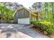 Beautiful exterior view featuring a two-car garage, driveway, and mature trees at 7635 Blandford Pl, Atlanta, GA 30350