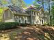 Charming two-story home featuring a neutral stucco exterior, complemented by lush landscaping at 7635 Blandford Pl, Atlanta, GA 30350