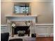 Traditional living room fireplace with white mantel, brick surround and hearth, perfect for cozy evenings at 7635 Blandford Pl, Atlanta, GA 30350