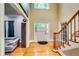 Bright foyer features hardwood floors, high ceilings, staircase, and a decorative front door with sidelights at 7635 Blandford Pl, Atlanta, GA 30350