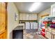 Functional laundry room with ample counter space, storage cabinets, and modern washer and dryer at 7635 Blandford Pl, Atlanta, GA 30350