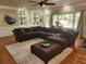 Inviting living room with large sectional sofa, built-in shelves, and natural light, ideal for relaxing at 7635 Blandford Pl, Atlanta, GA 30350