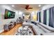 Comfortable living room with a large TV, a fireplace, a ceiling fan and lots of natural light at 7635 Blandford Pl, Atlanta, GA 30350