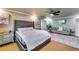 Spacious main bedroom with tufted headboard, sitting area, ceiling fan, and neutral decor at 7635 Blandford Pl, Atlanta, GA 30350