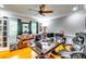 Hardwood-floor office features a leather sofa, several screens, and a comfy chair at 7635 Blandford Pl, Atlanta, GA 30350