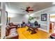 Office with a leather sofa, hardwood floors, a ceiling fan, and ample desk space at 7635 Blandford Pl, Atlanta, GA 30350
