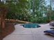 Inviting pool area with lush greenery, surrounded by ambient lighting for evening enjoyment at 7635 Blandford Pl, Atlanta, GA 30350