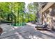 Backyard with luxurious pool, lush greenery, lounge chairs and outside dining area, great for entertaining at 7635 Blandford Pl, Atlanta, GA 30350