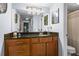 Bathroom featuring wooden cabinets, granite countertop, and an expansive mirror at 1445 Monroe Ne Dr # E25, Atlanta, GA 30324