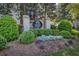 Landscaped entrance featuring the Carlyle Heights Condominiums sign, enhancing curb appeal at 1445 Monroe Ne Dr # E25, Atlanta, GA 30324