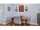 Dining area with wood floors, four chairs, and updated decorations on the wall at 1445 Monroe Ne Dr # E25, Atlanta, GA 30324
