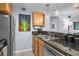 Well-lit kitchen with stainless steel appliances, wooden cabinets, and dark granite countertops at 1445 Monroe Ne Dr # E25, Atlanta, GA 30324
