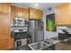 Kitchen featuring granite countertops, stainless steel appliances and wood cabinetry at 1445 Monroe Ne Dr # E25, Atlanta, GA 30324