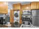 Bright kitchen featuring granite countertops, wooden cabinets, and stainless steel appliances at 1445 Monroe Ne Dr # E25, Atlanta, GA 30324