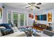 Bright living room features a ceiling fan, modern furniture, and a sliding door at 1445 Monroe Ne Dr # E25, Atlanta, GA 30324