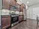 Stainless steel oven and microwave with dark wood cabinets and light backsplash at 1020 Broadview Dr, Marietta, GA 30062