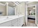 Bright bathroom with dual sinks, tile floors, and neutral finishes, providing a clean and functional space at 1850 Cotillion Dr # 3307, Atlanta, GA 30338