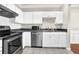 Bright and modern kitchen with stainless steel appliances, white cabinets, and tile flooring at 1850 Cotillion Dr # 3307, Atlanta, GA 30338