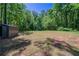 Large backyard with mature trees and a storage shed provides plenty of outdoor space at 210 Meadowbrook Dr, Mcdonough, GA 30253