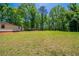 This large backyard offers plentiful space with mature trees, enhancing privacy and a tranquil atmosphere at 210 Meadowbrook Dr, Mcdonough, GA 30253