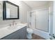 Bathroom features a shower with a sliding glass door, stylish vanity with a marble countertop, and wood look floors at 210 Meadowbrook Dr, Mcdonough, GA 30253