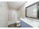 Bathroom with gray wood floors, stylish vanity with marble countertop, and shower with sliding glass door at 210 Meadowbrook Dr, Mcdonough, GA 30253