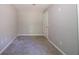 Carpeted bedroom with gray walls, a standard closet and an entry door at 210 Meadowbrook Dr, Mcdonough, GA 30253